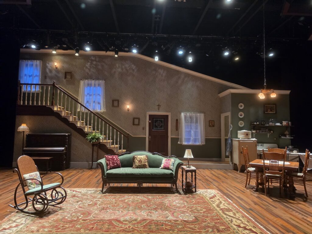The set of August Wilson's The Piano Lesson at Juilliard's Stephanie P. McClelland Drama Theater: the Charles family parlor in 1936 Pittsburgh, with the upright piano, staircase and kitchen.
